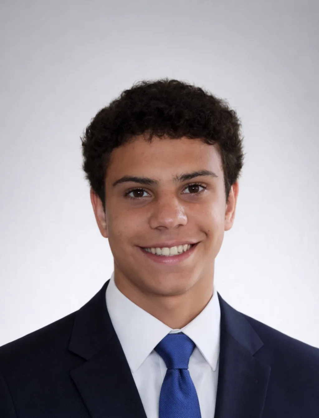 Professional headshot of Matias Zarembka in a navy suit and blue tie